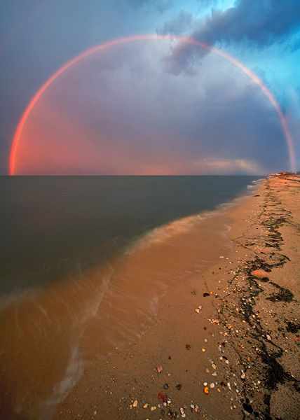 The entire arc of a sunset rainbow over Big Stone Beach, Delaware ...