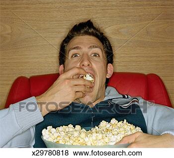 young-man-eating_~x29780818.jpg